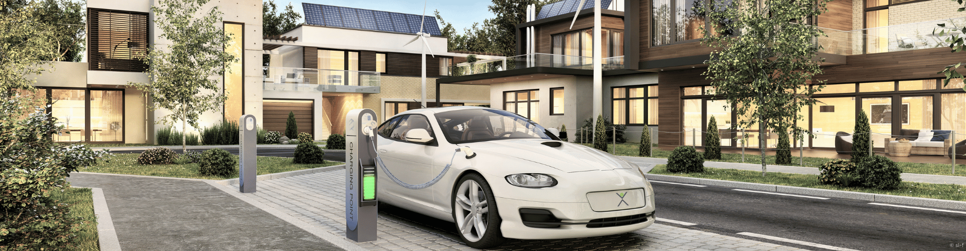 Modern buidling complex with solar panels, wind turbines and an electric vehicle charging in the front